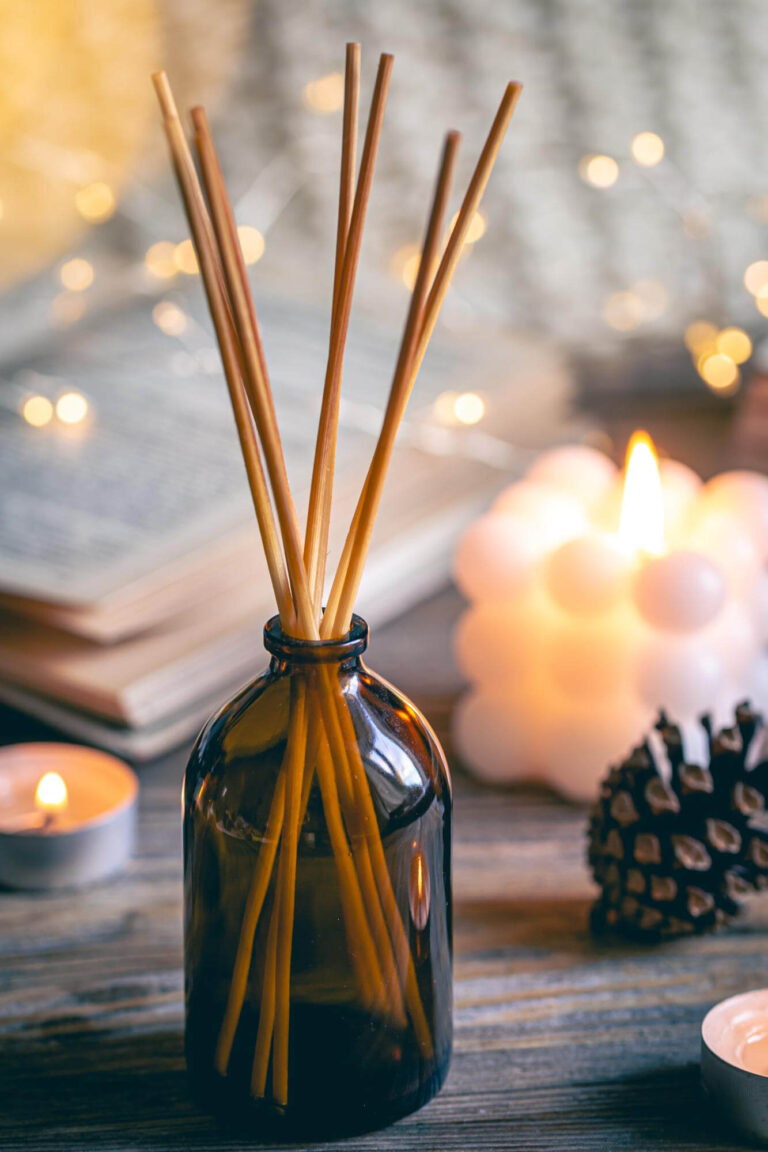 winter spa composition with incense sticks candles bokeh lights